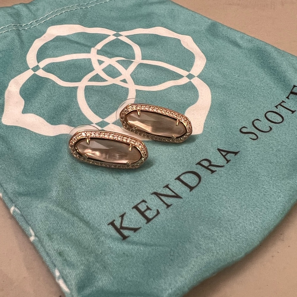 Kendra Scott rose gold earrings.